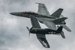 An F4U Corsair and F/A-18 Super Hornet make a side by side pass for the crowd 