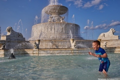 Young boy enjoys the James Scott Memorial Fountain.